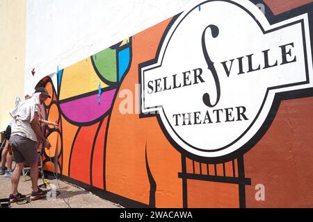 The painters' are painting the sign on the wall/. Stock Photo