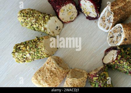 Rolls of turkish delight with different flavors and fillings close up on table. Turk Lokumu bars Stock Photo