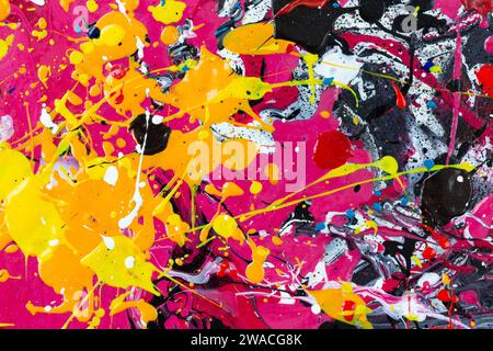 Macro close-up of an abstract, messy, vibrant and very colorful acrylic paint background. Splashes, blobs, drips, stains and spray. Stock Photo