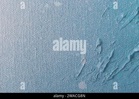 Macro close-up of an abstract white, light blue and turquoise spray paint on textured background. Bright and colorful canvas with copy space. Stock Photo