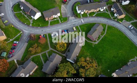 Unique drone view of semi-detached houses connected by paths along a bendy road. Stock Photo