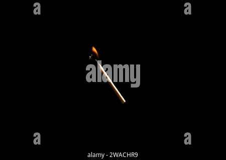 Lit and falling match on a black background. Stock Photo