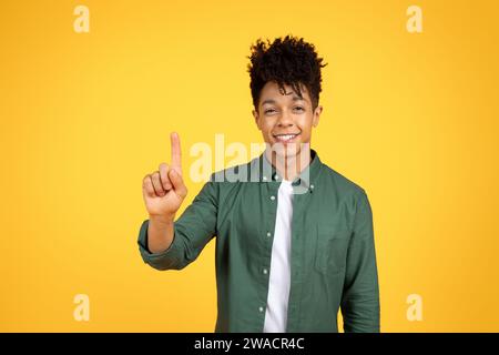 Excited Black Guy Touching Invisible Screen Or Pushing Button Stock Photo