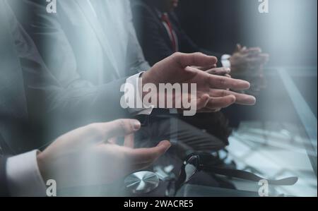 Business partners discuss financial reports, plan an investment strategy. Team of three Stock Photo