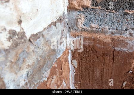 Damaged damp plaster exposing brick in a bathroom. Home improvement problems concept Stock Photo
