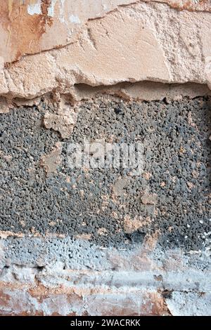 Damaged damp plaster exposing brick in a bathroom. Home improvement problems concept Stock Photo