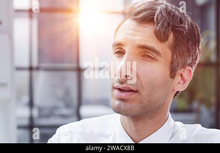 Confident and focused young designer standing in an office Stock Photo