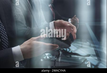 Business partners discuss financial reports, plan an investment strategy. Team of three Stock Photo