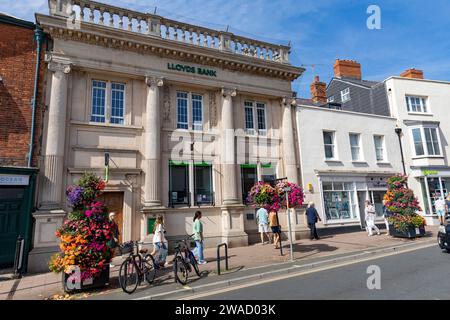 Lloyds bank, branch of Lloyds bank on the high street in Sidmouth,Devon,England, sunny autumn day with flowering hanging baskets,England,2023 Stock Photo