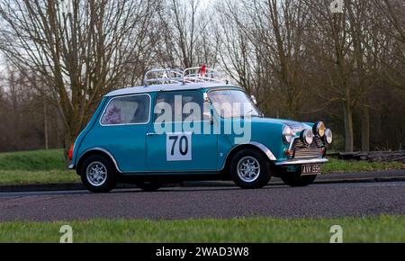 Stony Stratford,UK Jan 1st 2024.  1970 turquoise Mini 1000 car arriving at Stony Stratford for the annual New Years Day vintage and classic vehicle fe Stock Photo