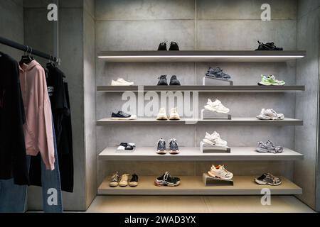 SINGAPORE - NOVEMBER 07, 2023: various footwear on display in Balenciaga store inside Singapore Changi Airport. Stock Photo