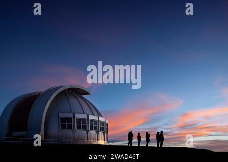 Silhouette of people watching sunset at observatory Stock Photo