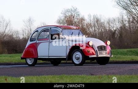 Stony Stratford,UK Jan 1st 2024. 1987 red Citroen 2CV V6 Dolly limited edition car arriving at Stony Stratford for the annual New Years Day vintage an Stock Photo