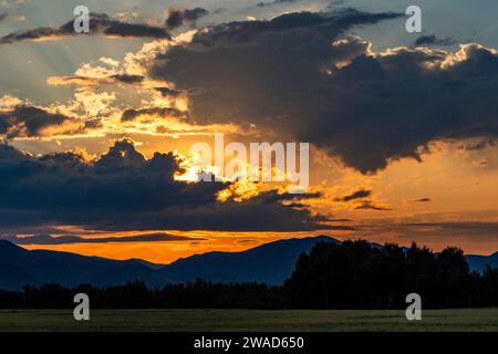 Beautiful sunrise over silhouettes of mountains Stock Photo
