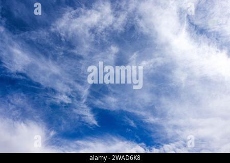 Wispy white clouds in blue sky Stock Photo