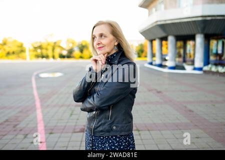 Portrait of thoughtful woman standing in front of building Stock Photo