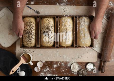 Directly above view of baker preparing bread in kitchen Stock Photo