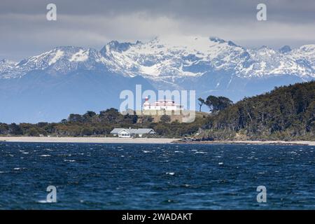 abandoned lighthouse over a hill next to the Pacific Ocean Stock Photo