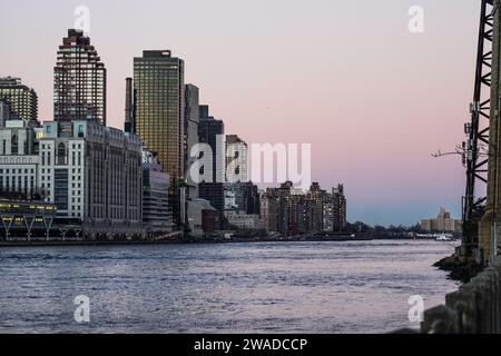 Manhattan, US, 02/01/2024, The general view of Manhattan from Roosevelt Island. Roosevelt Island, nestled in the East River between the boroughs of Manhattan and Queens in New York City, offers a unique blend of tranquility and urban living. Accessible by tram, subway, or bridge, this narrow island boasts a serene atmosphere distinct from the bustling city nearby. Home to a diverse community, it features a mix of residential complexes, parks, and historic landmarks like the renovated Blackwell House. Visitors and residents enjoy scenic waterfront views, tree-lined pathways perfect for strolls  Stock Photo