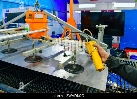 A worker is pressing a steel plan control button to enter the steel cutting process in the industrial factory Stock Photo