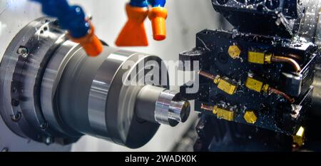 The multi-tasking CNC lathe machine milling cut the metal part, The hi-technology parts manufacturing Stock Photo