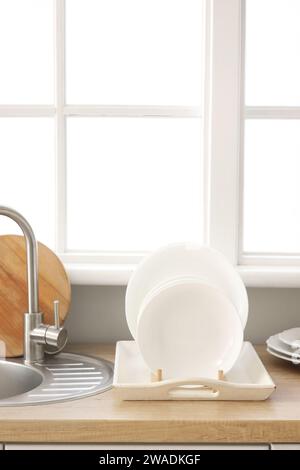 Kitchen counter with sink and plate rack near window Stock Photo - Alamy