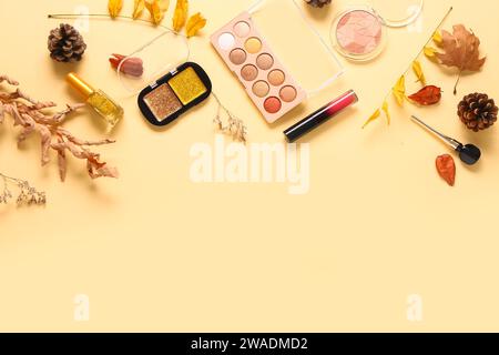 Beautiful autumn composition with different makeup products on beige background Stock Photo