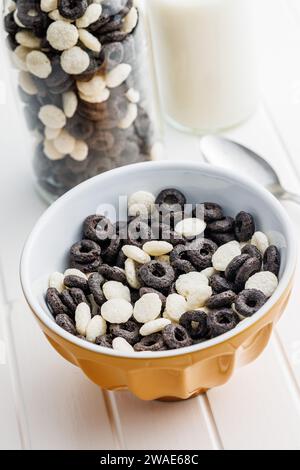 Sweet breakfast cereals in bowl on the white table. Stock Photo