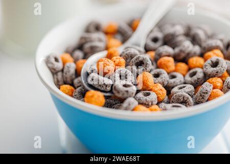 Sweet breakfast cereals in bowl on the white table. Stock Photo