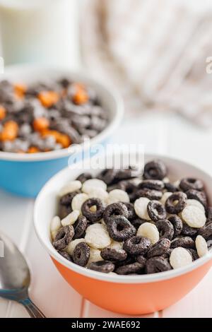 Sweet breakfast cereals in bowl on the white table. Stock Photo