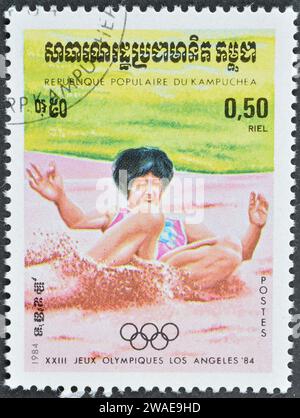 Cancelled postage stamp printed by Cambodia, that shows Long jump, promoting Summer Olympics in Los Angeles, circa 1984. Stock Photo