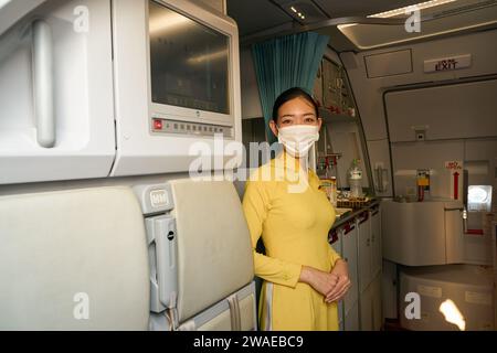 HO CHI MINH CITY, VIETNAM - MARCH 30, 2023: Vietnam Airlines flight attendant in uniform on board of Airbus A321neo. Stock Photo