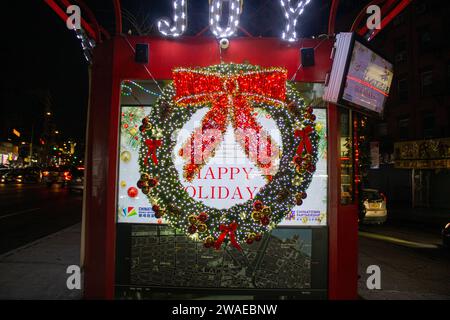 A festive phone booth with a 'Happy Holidays' sign on the front on Christmas Stock Photo