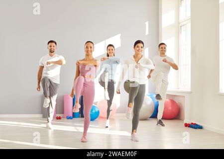Joyful Group Fitness Workout in the Gym Stock Photo