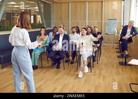 Group of people attend business seminar in meeting room and listen to business coach. Stock Photo