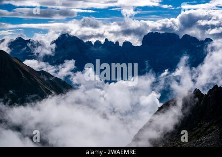 The main range of Brenta Dolomites, clouds moving around in the valleys, seen from the mountain hut Rifugio Cornisello. Stock Photo