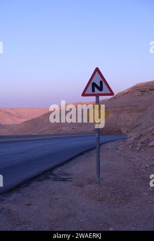 Double bend first to right sign between the mountains Stock Photo