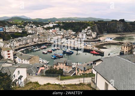 Above view to the moored boats in harbour of Luarca during cloudy winter day. Principal town in municipality of Valdes in Asturias, northern Spain. Tr Stock Photo