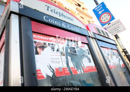 Islington London - Ripped posters showing kidnapped Israeli victims of the 7th October 2023 attack by Hamas on a north London phonebox - taken January Stock Photo