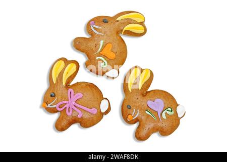 Three easter gingerbread cookies in the shape of a bunny isolated on a white background. Stock Photo