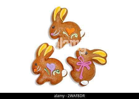 Three easter gingerbread cookies in the shape of a bunny isolated on a white background. Stock Photo