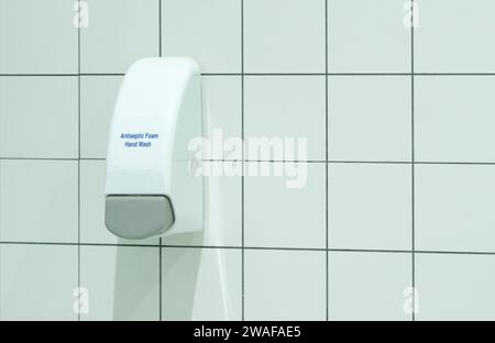 Automatic drug distribution arm, antiseptic foam dispenser is sticking on the toilet or restroom wall to dispense antiseptic foam to sterilize custome Stock Photo