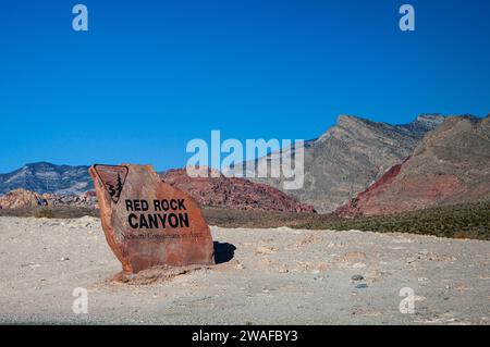 Las Vegas, Nevada, USA - November 8th, 2023: Red Rock Canyon, sign on boulder in front of mountains Stock Photo
