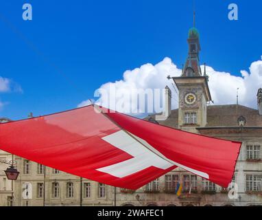 View of the city center in Lausanne with big Swiss flag Stock Photo