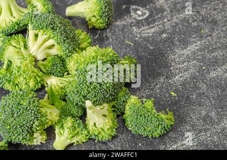 Broccoli florets on dark background. Concept of simple ingredients for health Stock Photo
