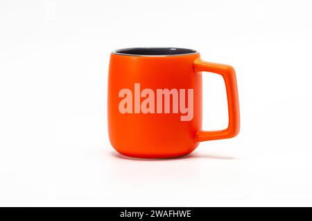 Large orange ceramic mug isolated on white background. This is clipping path. Stock Photo
