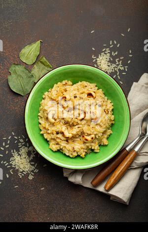 Ven Pongal (Khara Pongal), traditional Indian savoury rice dish made during celebrating Pongal festival, served in bowl top view on concrete rustic Stock Photo