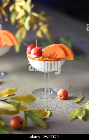 Homemade panna cotta dessert in the glass. Panna cotta dessert with pumpkin mousse in the glasses decorated with permission Stock Photo