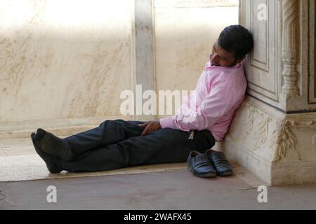 Agra, India - April 17 2017: Indian man sleeping on marble floor in Agra Fort Stock Photo