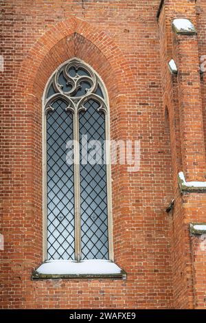 a fragment of the facade of a historic neo-Gothic church. Stock Photo
